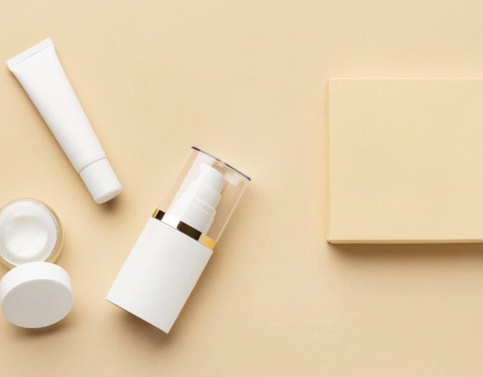 Custom cosmetic packaging on a beige background.